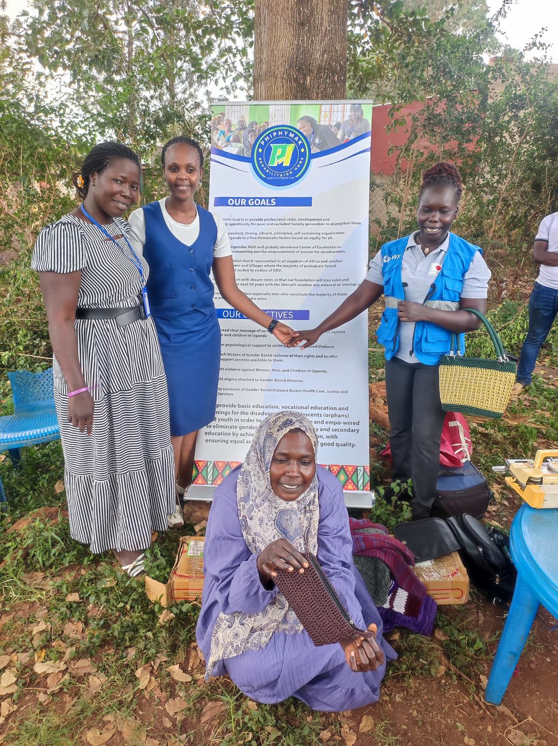 A PhiphyMak volunteer handing supplies to a mother at the camp