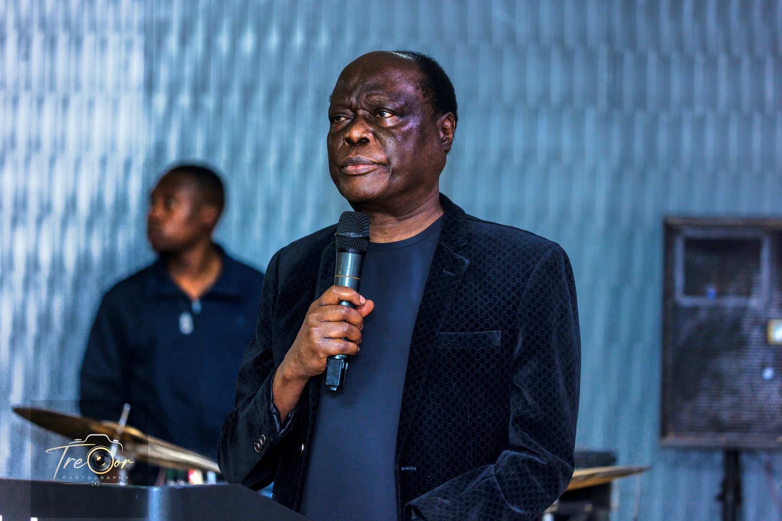 A guest speaking to the room during the evening