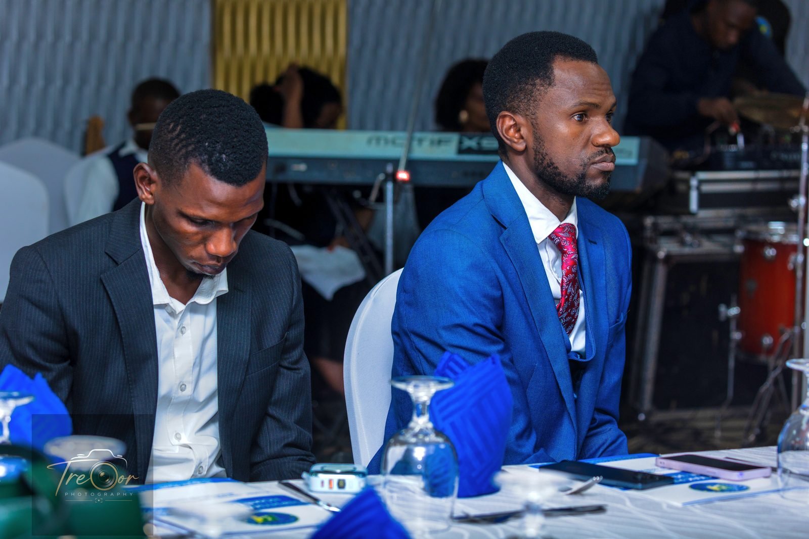 Two guests in formal wear following the programme