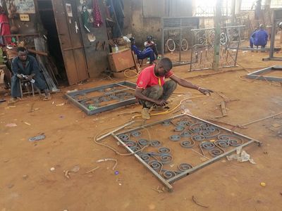 A PhiphyMak trainee at work on a metal frame during welding training