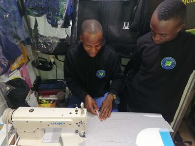 A trainee working at a sewing machine during tailoring training